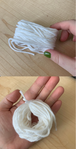 A diagram showing the progression of building a ghost pompom decoration. First, an image showinga bundle of yarn held in a person's hand. Then, an image of the yarn with another piece of yarn tied through it, turning it into a little donut shaped lump.